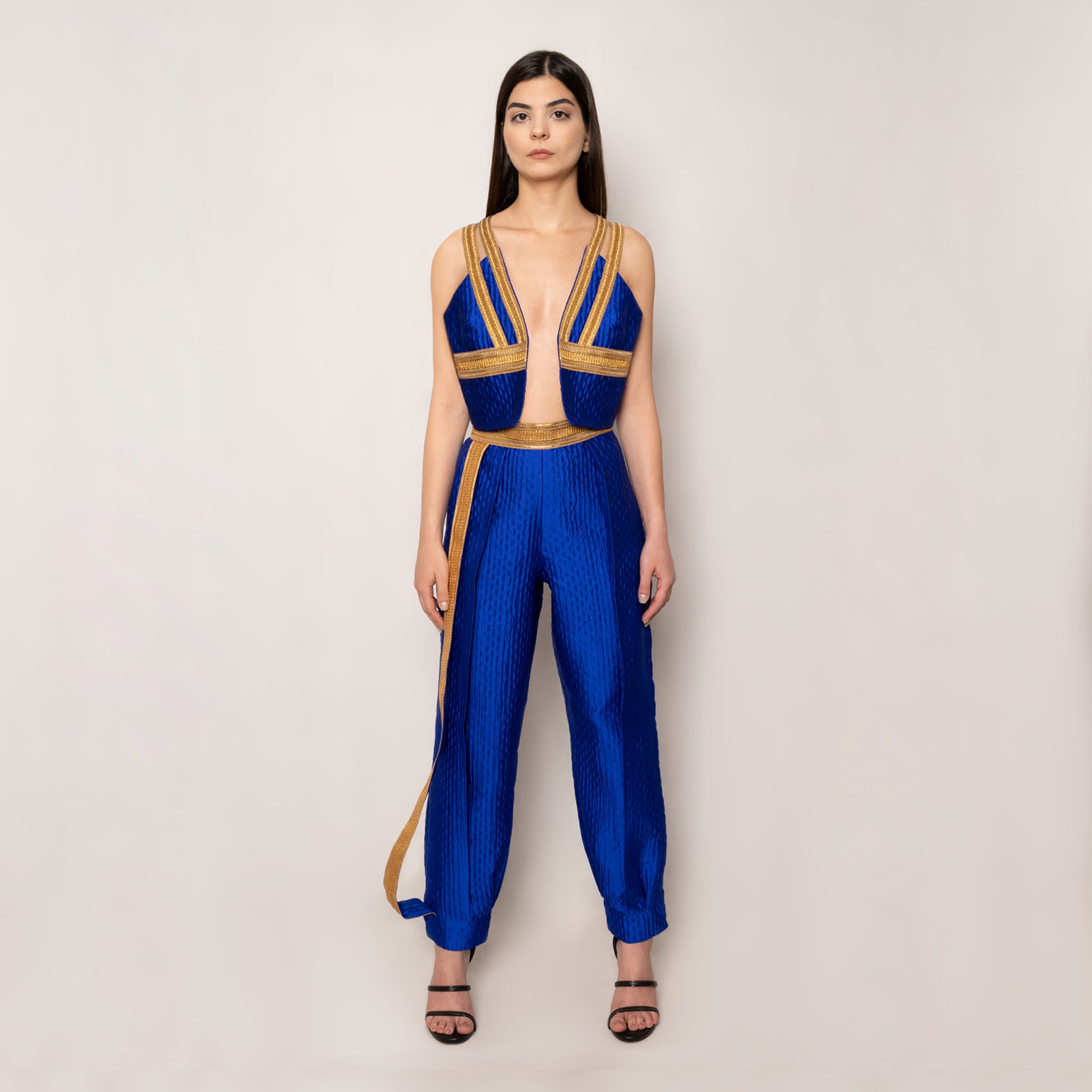 Front view of the Golden Nomad Set in Klein Blue by Tehran, featuring a sleeveless jacquard vest with a plunging V-neckline, keyhole detail at the back, and elegant trims. Paired with tapered pants with elasticated ankles and a concealed side zip for a tailored and sleek look.