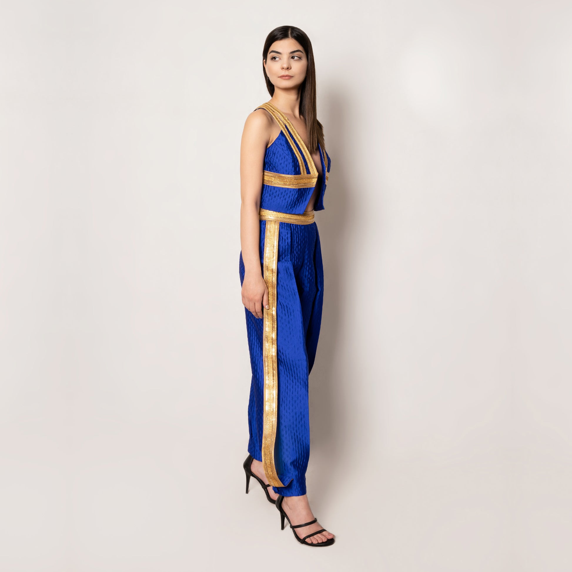 Another side view of the Golden Nomad Set in Klein Blue by Tehran, focusing on the bold jacquard fabric, sleek sleeveless vest, and matching tapered pants, designed for a modern, fashion-forward look.