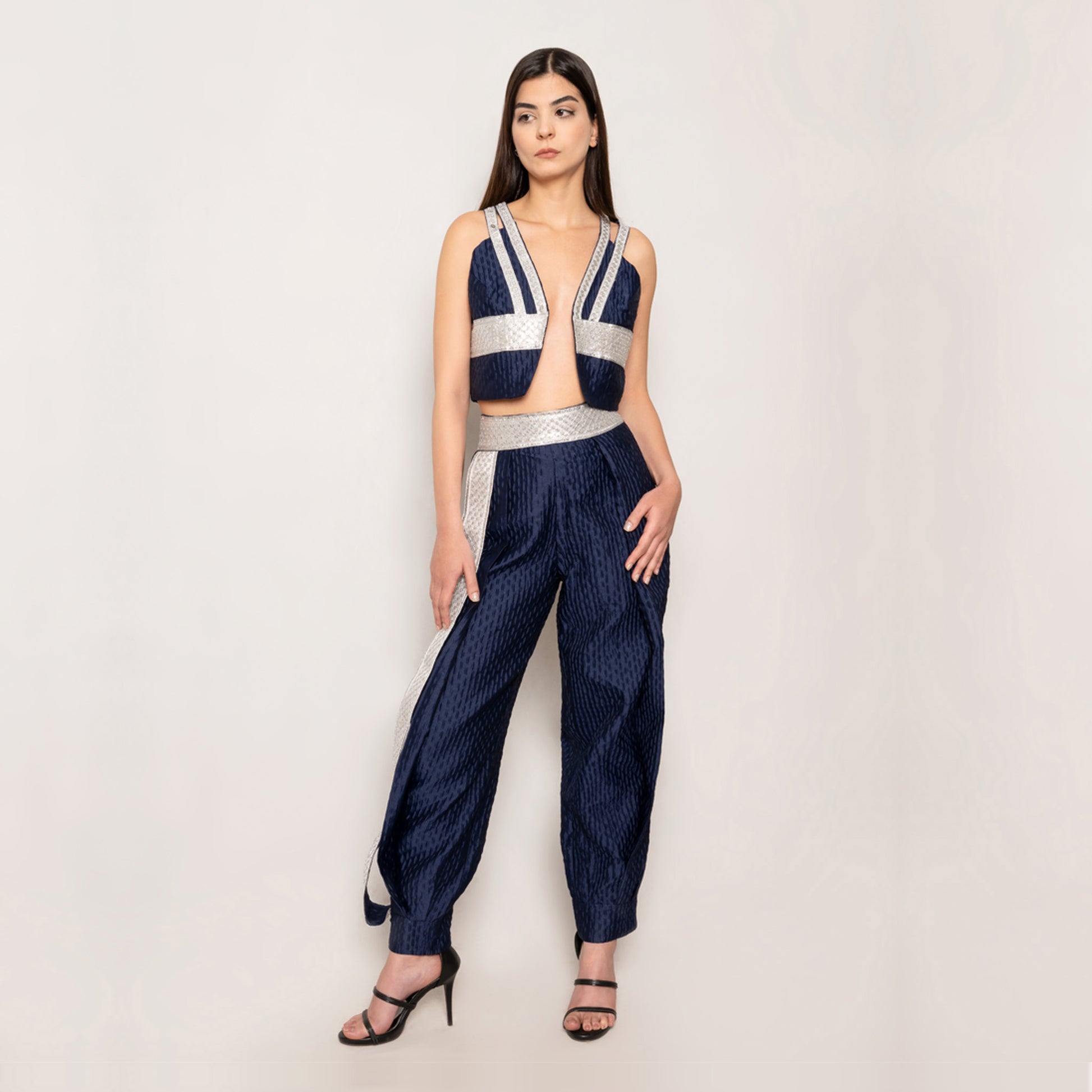 Front view of the Golden Nomad Set in Navy Blue by Tehran, featuring a sleeveless jacquard vest with a plunging V-neckline, keyhole detail at the back, and sophisticated trims. Paired with tapered pants with elasticated ankles and a concealed side zip for a tailored, sleek look.