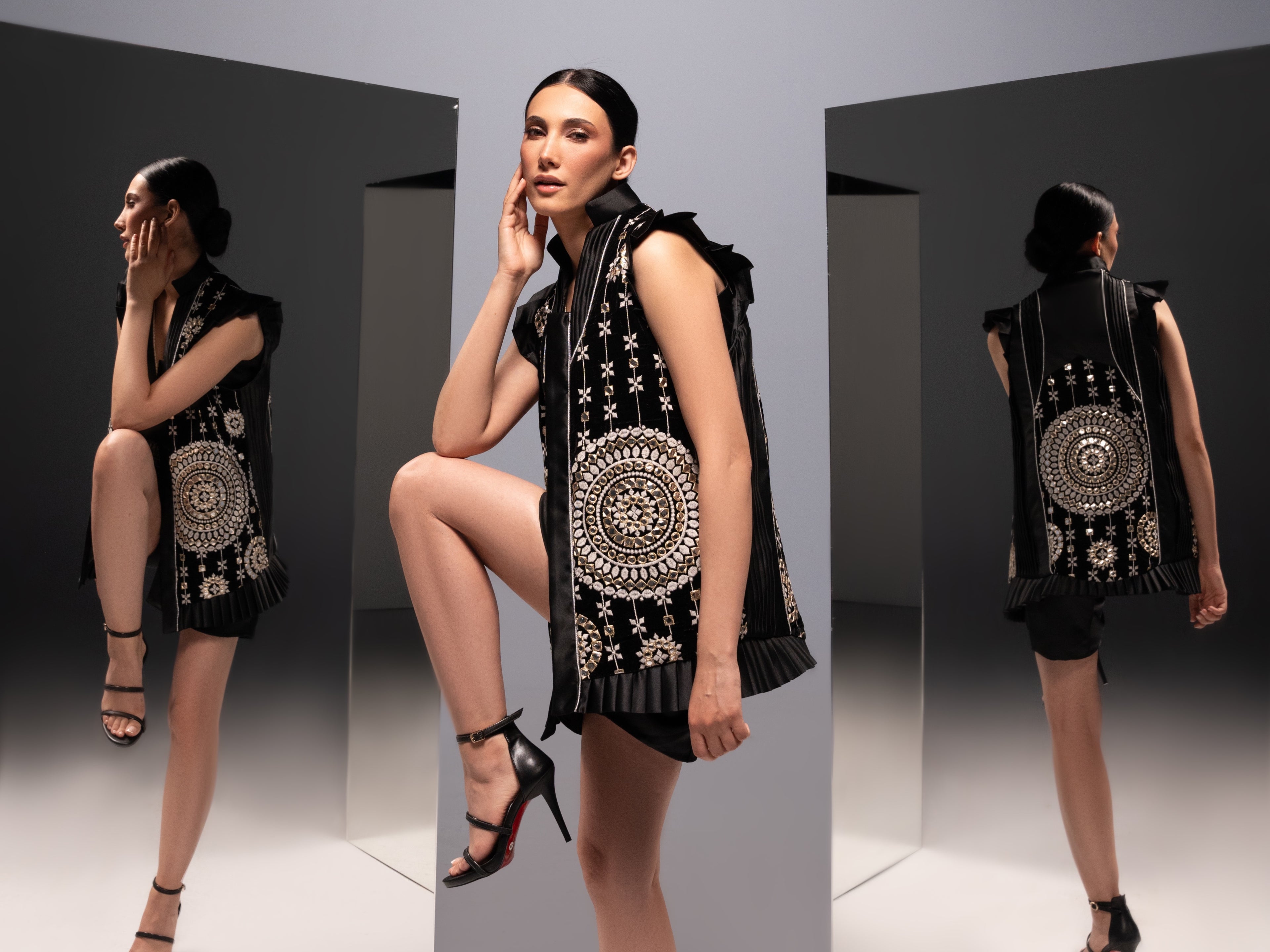 Front view of the "Mirror Magic Long Vest" by Tehran Official. This black silk vest with intricate mirror work blends traditional craftsmanship with modern elegance. Perfect for layering over casual or formal outfits, it suits events like evening gatherings or cultural celebrations, offering timeless sophistication.