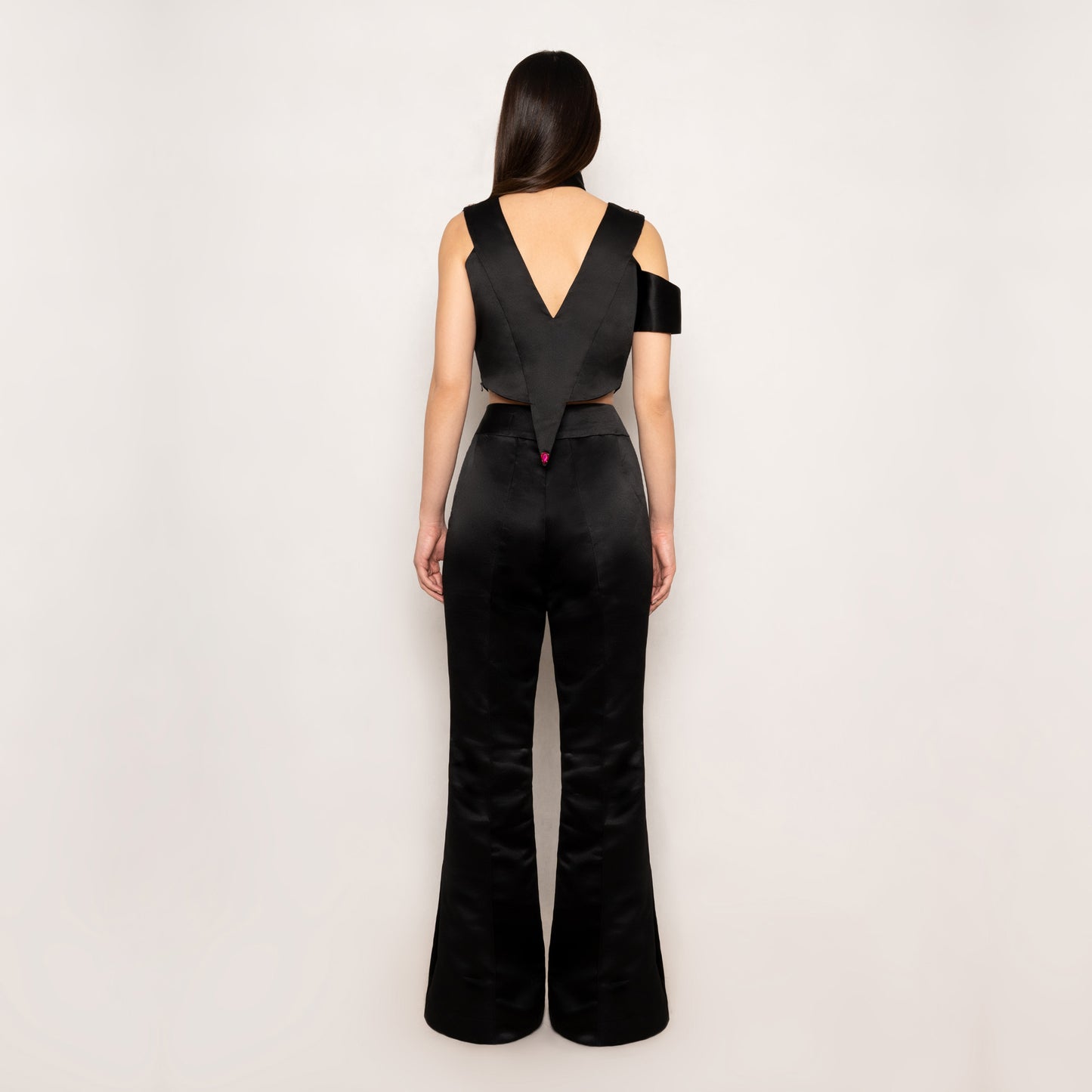 Back view of the Rose Essence Set by Tehran, showcasing the smooth black silk fabric and tailored fit of the top and pants. The clean silhouette emphasizes sophistication and elegance.