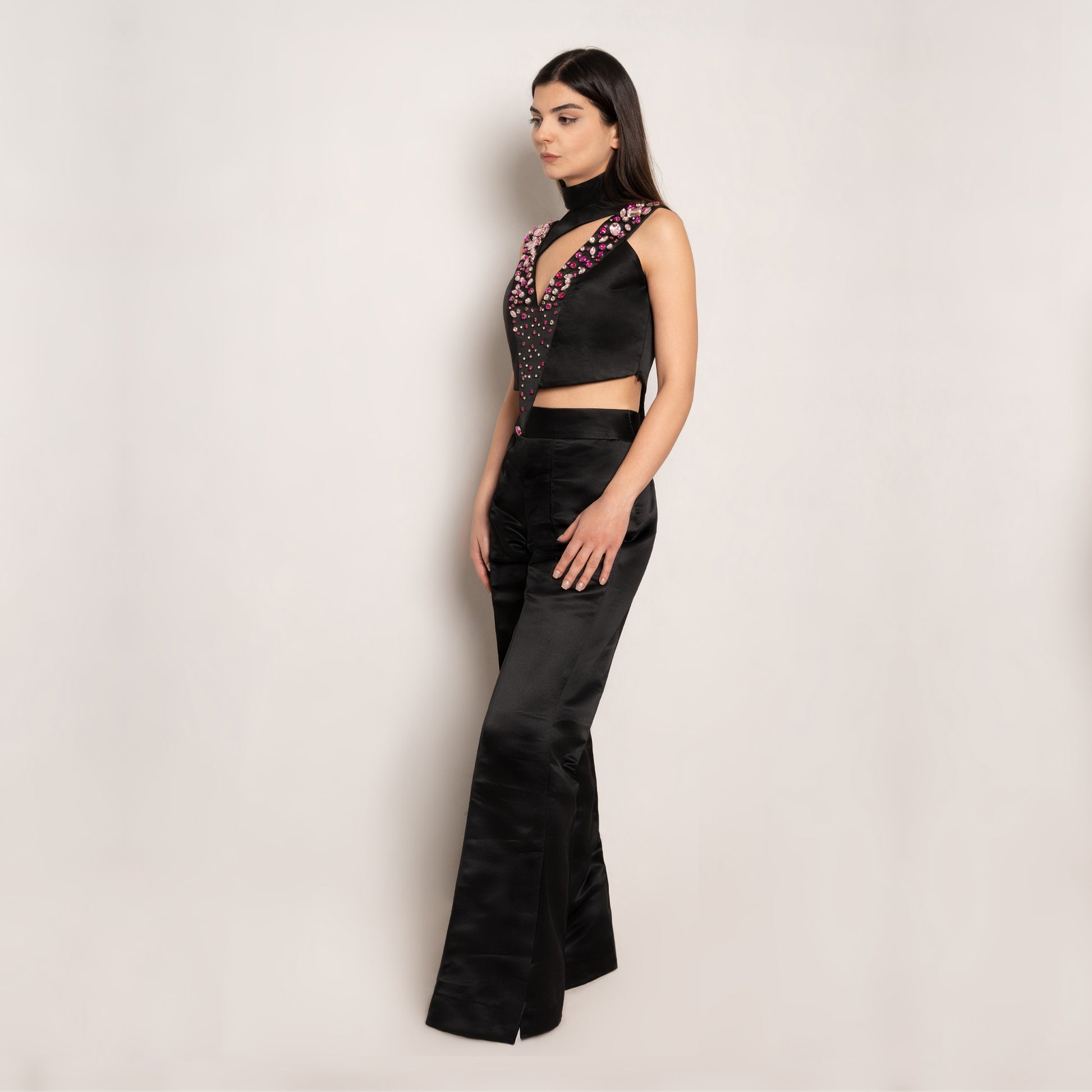 Side view of the Rose Essence Set by Tehran, highlighting the luxurious flow of the 100% silk fabric, the dramatic flared cuffs of the pants, and the intricate rhinestone embellishments on the top.